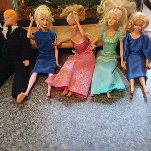 Barbies 4 and a guy doll.